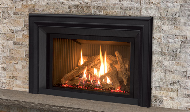 Inviting gas fireplace insert with a black frame, lively flames, and a log set, against a textured stone backdrop with a mantel shelf.
